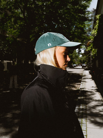 forest green cap.