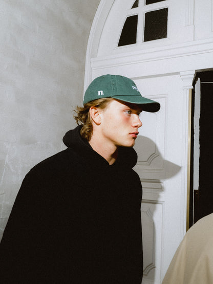 forest green cap.